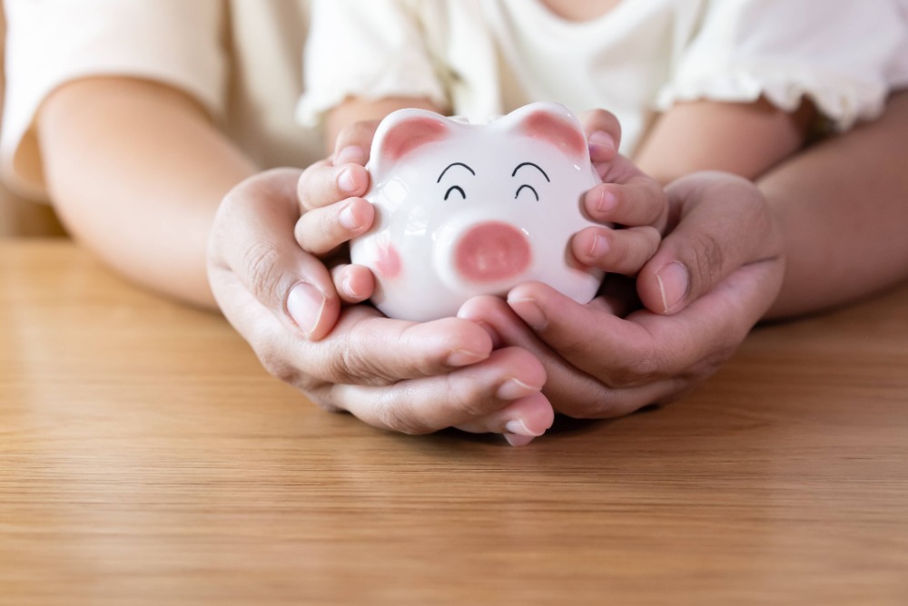 Father and daugther with piggy bank