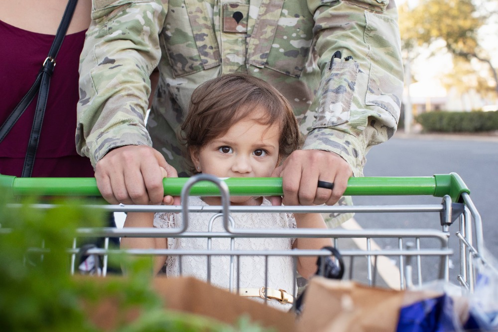 Parents and child pushing shopping cart