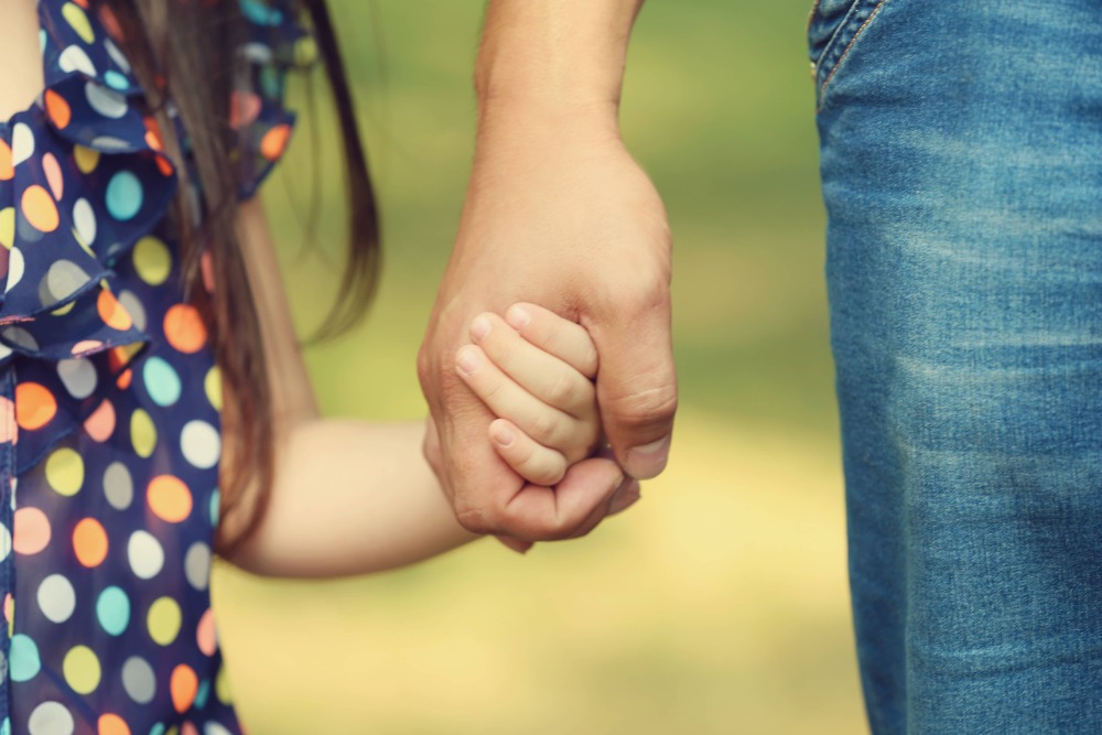 Parent, child holding hands