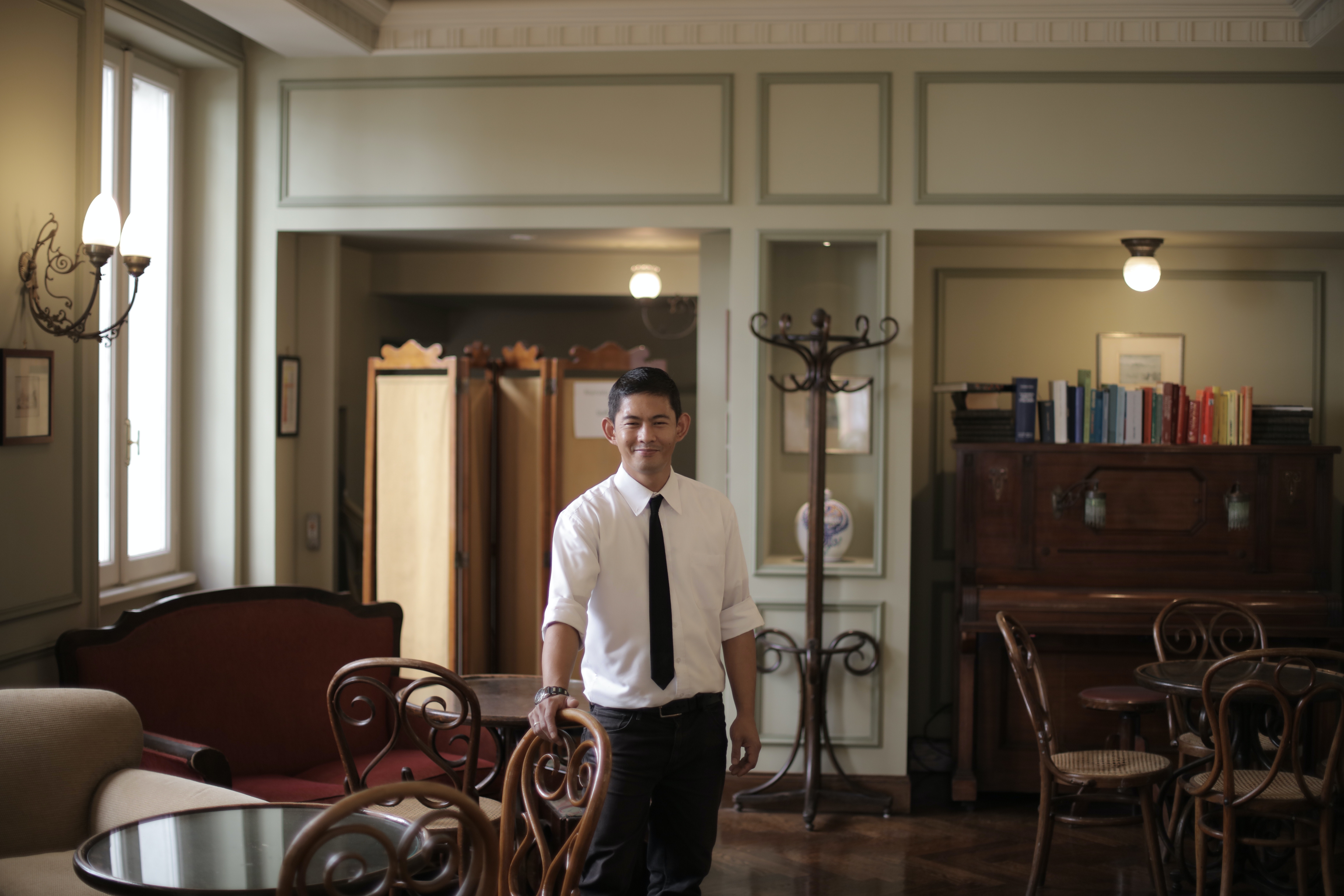 Cheerful restaurant manager smiling at camera