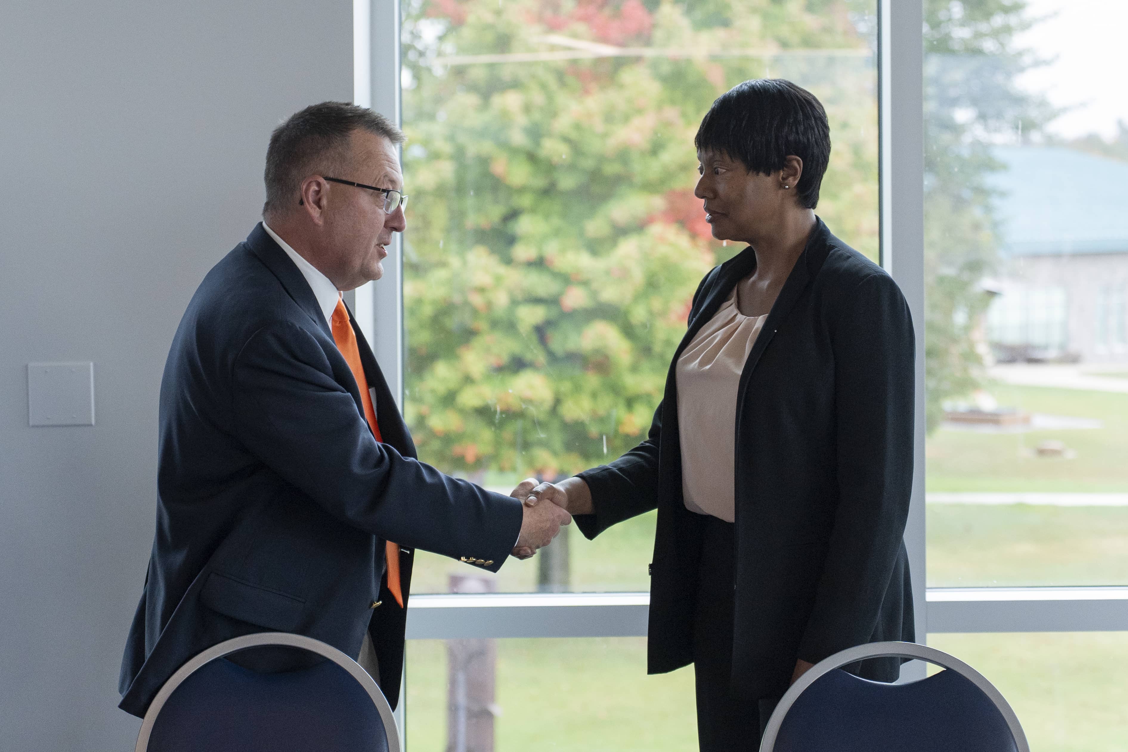 NCMC President David Roland Finley shakes hands with Ann Lampkin-Williams, dean of UM-Dearborn's College of Education, Health & Human Services.