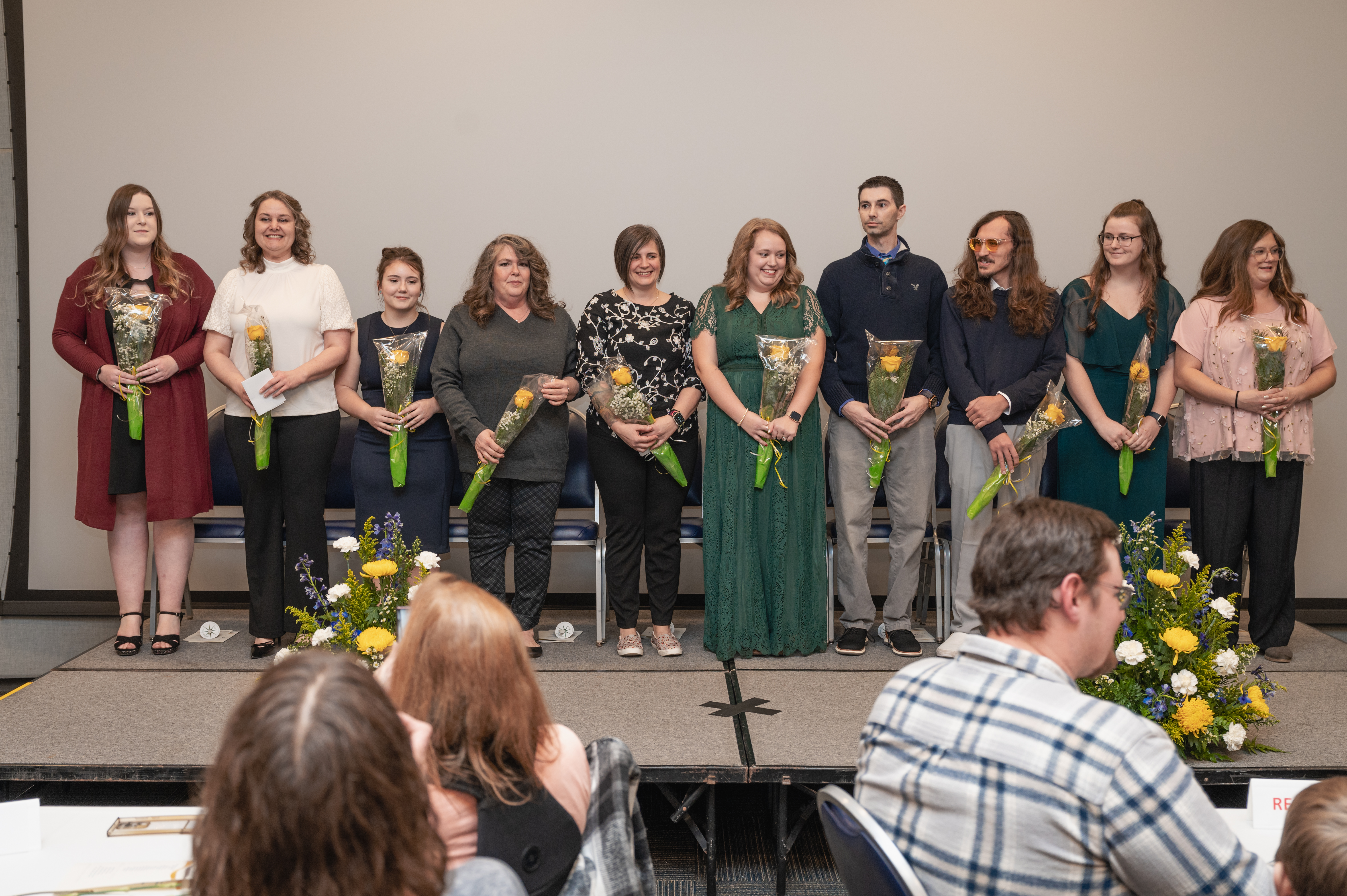 Ten graduates of North Central Michigan College’s inaugural Practical Nursing program stand together on stage during the December 12, 2024, pinning ceremony.