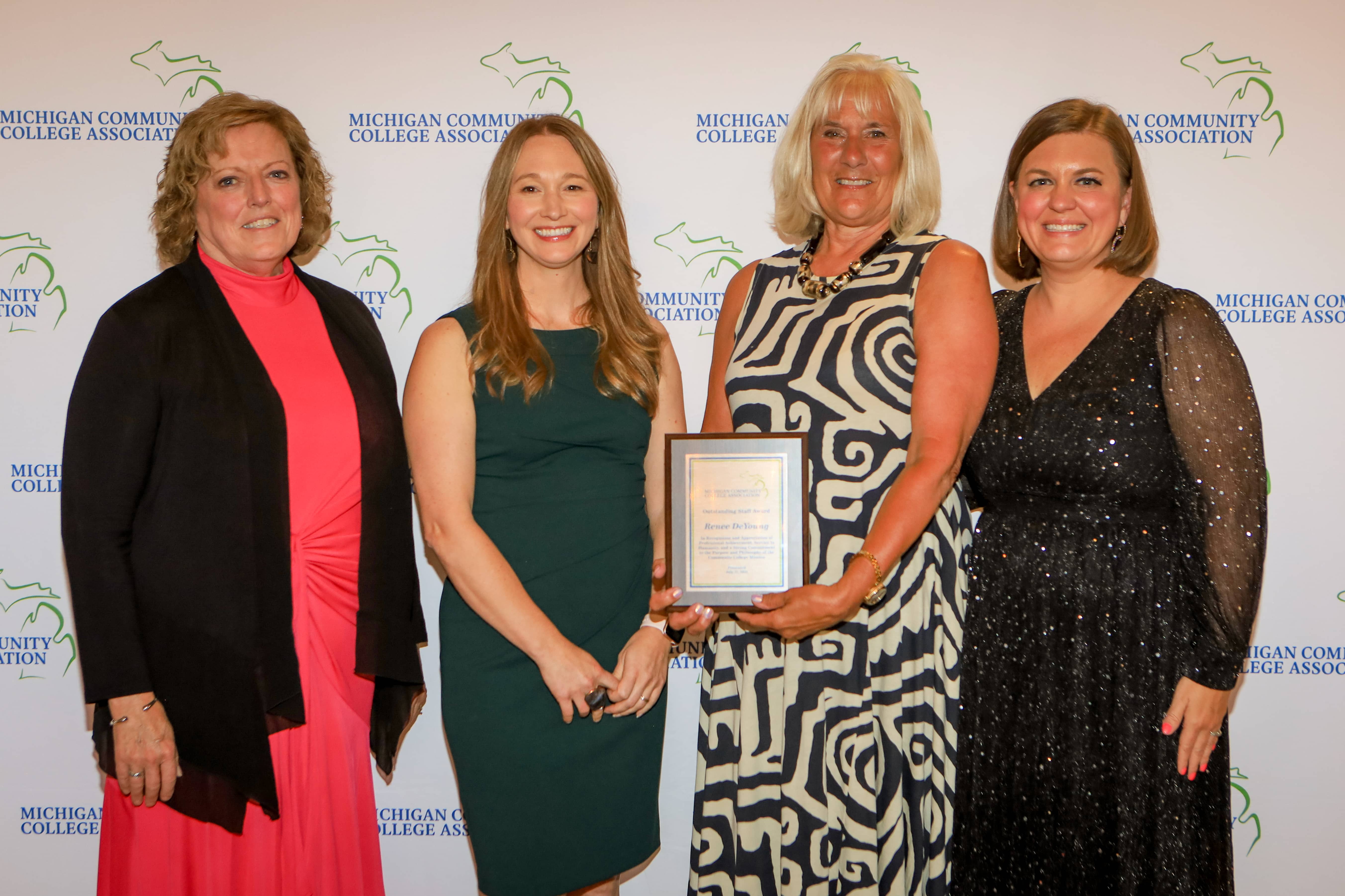 Renee DeYoung of North Central Michigan College receives the 2025 Michigan Community College Association Outstanding Staff Award at the MCCA Summer Conference on Mackinac Island, joined by Sherry Wyman, Chelsea Platte, and Brandy Johnson.