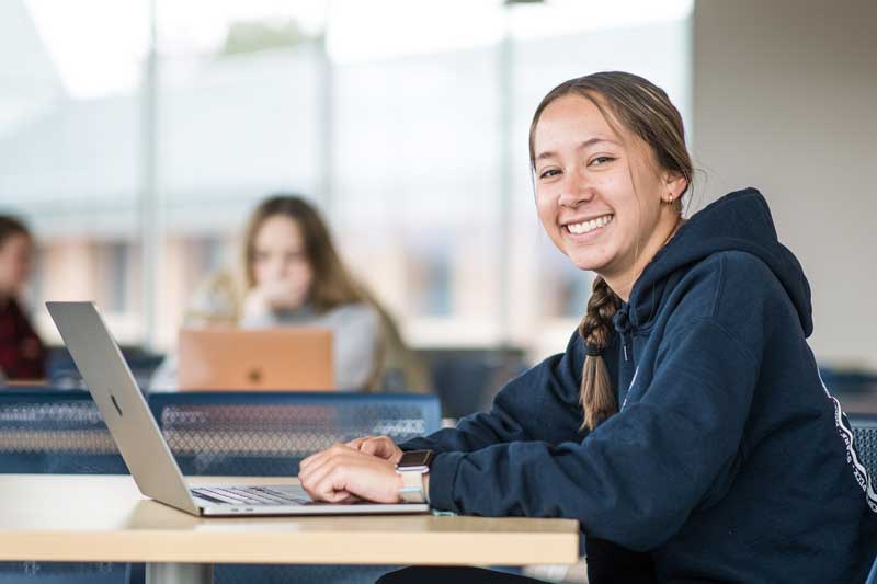 college student working on a laptop