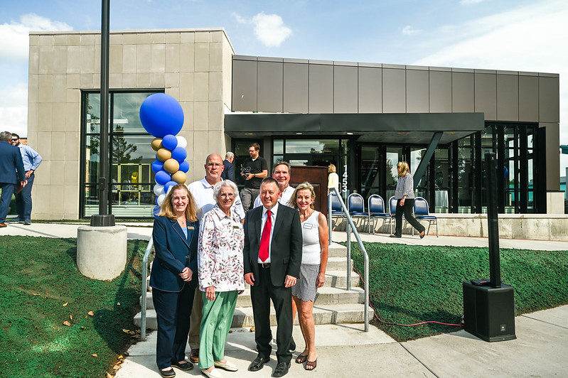 A groupd of people stand in front of the Martin Jahn Career and Technical Education Center.